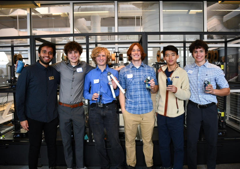 The Smart Tongs team holding the prototype